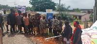 The chiefs and elders gathered around one of the destroyed signboard