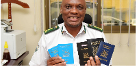 Mr Simon Mundeyi, the Internal Affairs spokesperson, displays Ugandan passports at the ministry’