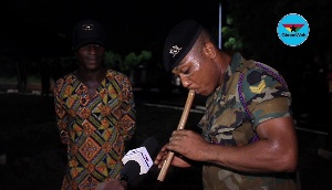 Corporal Fresher performs a dirge in honour of Major Mahama