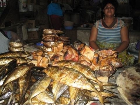 A woman selling smoked fish