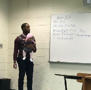 Mathematics professor, Nathan Alexander carrying the baby of his student