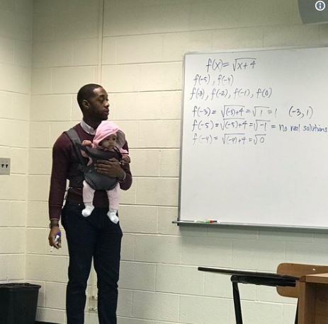Mathematics professor, Nathan Alexander carrying the baby of his student