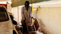 A Sudanese man displays unexploded munitions found at a school in Khartoum