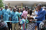 Madam Akosua Frema Osei-Opare cutting the ribbon to mark the handing over of the vehicles