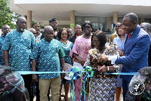 Madam Akosua Frema Osei-Opare cutting the ribbon to mark the handing over of the vehicles