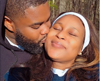 Berla Mundi and her husband in a romantic pose