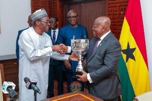 Speaker of Parliament, Alban Bagbin presenting the cup to President Akufo-Addo