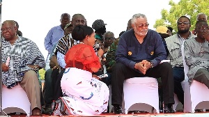 Anita Desoso, National Vice Chairperson of the NDC kneeling before Rawlings