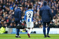 Brighton's Tariq Lamptey being escorted from the pitch after suffering an injury