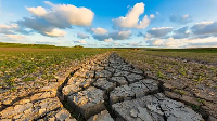 Arid and dry cracked land due to climate change and global warming