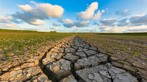 Arid and dry cracked land due to climate change and global warming