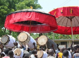 Residents welcome chief with drumming and umbrellas.    File photo.