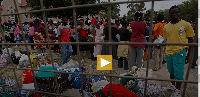 Zimbabwean citizens seen at a community centre with their belongings