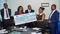 DCOP Tiwaa Addo-Danquah receiving a cheque from Frimps Oil on behalf of Ghana Police Service