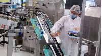 An employee at work on a production line at pharmaceutical company