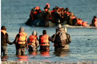Migrants board a small boat in an attempt to reach Britain, April 8, 2026 in Malo-les-Bains