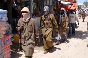 Armed al-Shabab fighters patrol Bakara Market in Mogadishu, Somalia