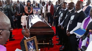 Kiptum's widow Asenath Rotich, in the pink jacket, gathered with her family by her husband's coffin