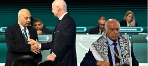 Gianni Infantino shakes hands with Moshe Zuares as Jibril Rajoub exits stage