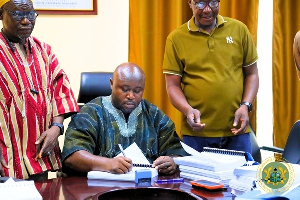 Savannah Regional Minister Salisu Be-Awuribe signing the contract