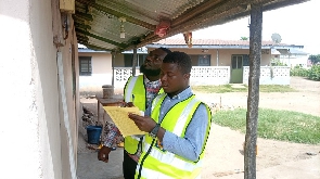 A staff of the ECG checking a meter