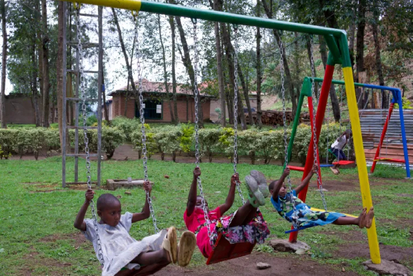 Children play on playground equipment at the Mutobo Demobilisation and Reintegration Centre