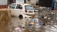 A vehicle is seen submerged at Asylum Down due to the heavy downpour