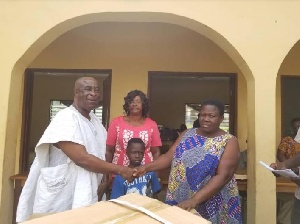 MCE for Birim Central, Kwabena Bempong presenting items to the physically challeged