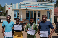 Healthcare workers and patients pose with their certificates after recovering from Ebola in Beni