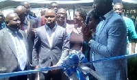Dr. Okoe Boye cut a tape, symbolizing the official opening of the office