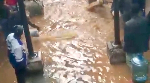 A picture of inmates standing in the flooded water