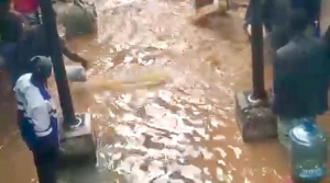 A picture of inmates standing in the flooded water