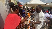 A beneficiary receiving a bag of rice