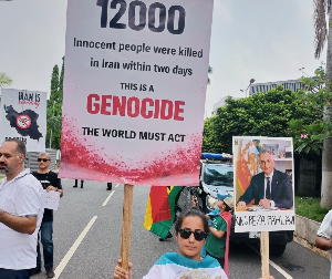 A lady holding placards reading; 12000 Innocent people were killed in Iran within two days