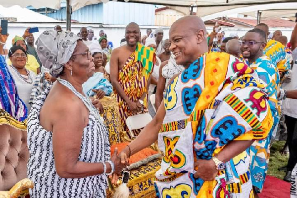 two traditional leaders exchange greetings