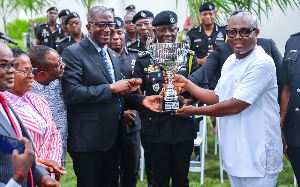 IGP Dampare (middle) receiving the trophy