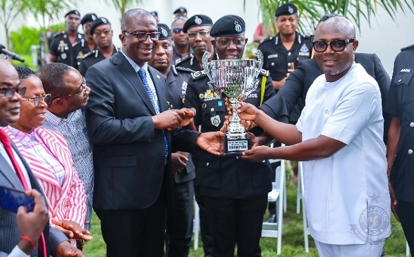 IGP Dampare (middle) receiving the trophy