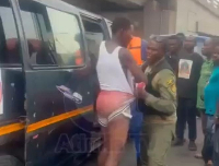 The trotro driver being arrested by an officer for overpricing transport fares