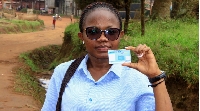 Congolese law student Stephanie Mbafumoja holds her voter identity card