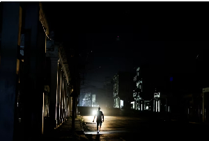 A man walks down a dark street as Cuba's electricity grid collapsed late on Sunday