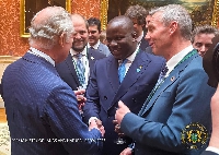 Abu Jinapor in a warm handshake with the British monarch