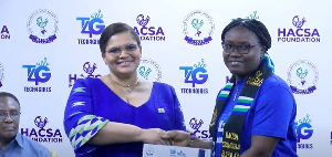 Mrs Svanikier Presenting A Certificate To One Of The Graduating Beneficiaries.jpeg