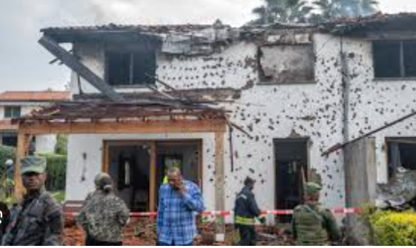 Army and firefighters work at a house damaged by a drone strike in Goma