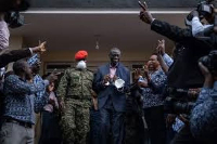 Uganda's veteran opposition figure Kizza Besigye is escorted by military police