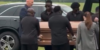 A Picture of George Blays body being carried in a casket