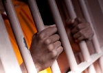 File photo of a person behind bars
