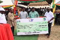 Dr. James Rajamani and Dr Emmanuel Rajamani presenting a dummy cheque to the Bono East minister