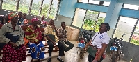 A facilitator addressing the aged as part of the health screening exercise