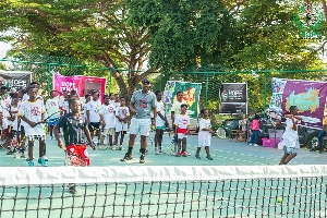 Cedric Dzelu On Tennis Court With Children 