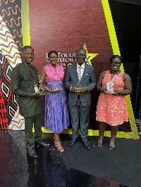 Executives captured in a photo with the awards